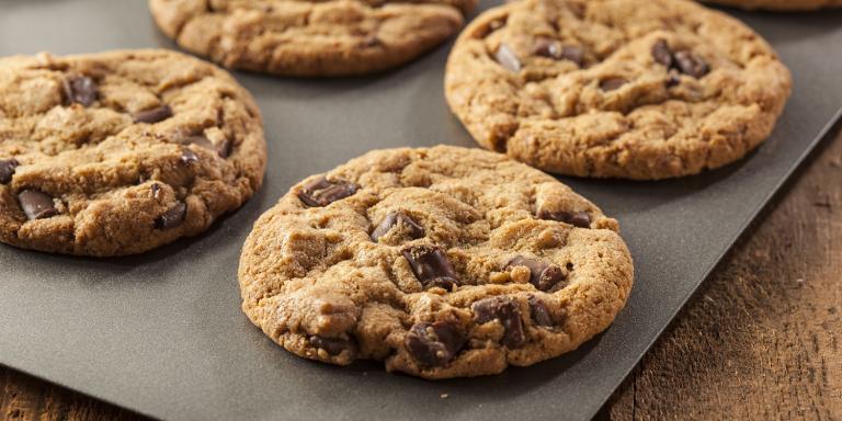 Fresh Peanut Butter Chocolate Chip Cookies on a baking sheet.